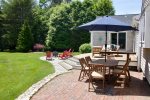 Outdoor dining with umbrella, lounge seating, fire pit with Adirondacks 